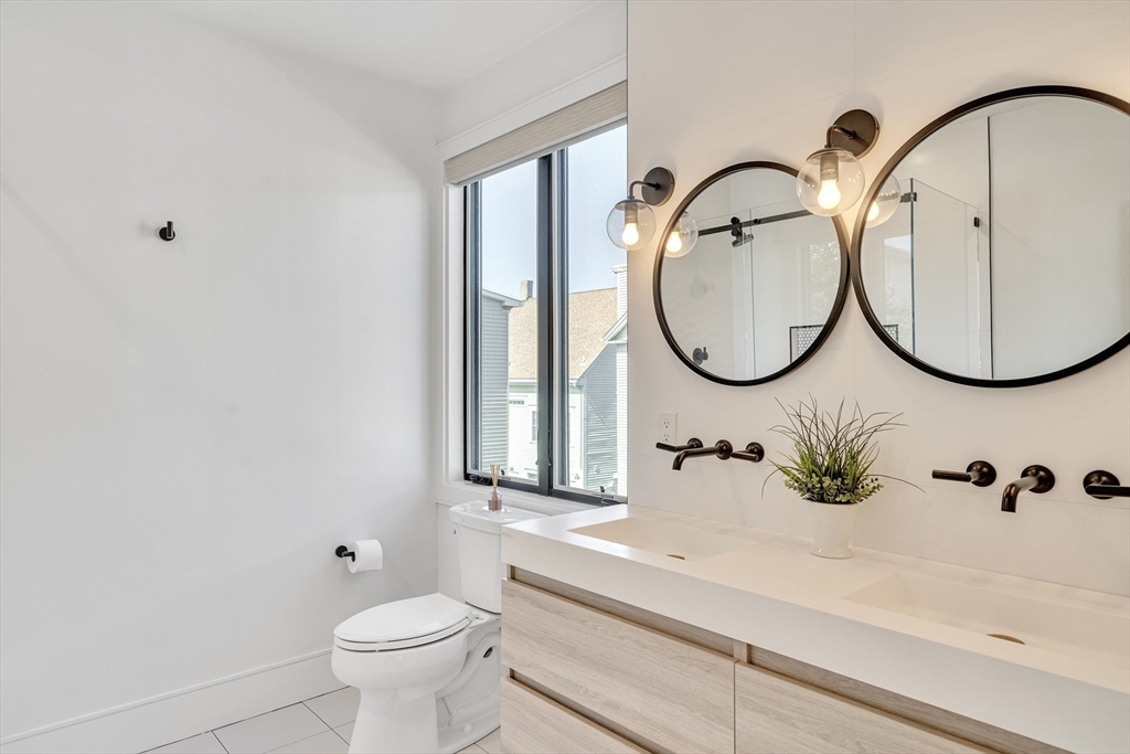148 West 9th Street, Unit 6 Boston, MA 02127 - Photo 14 of 21 a bathroom with a sink and a mirror