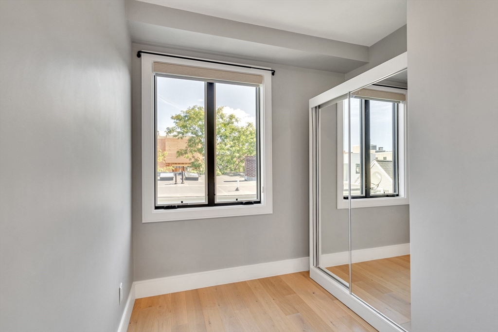 148 West 9th Street, Unit 6 Boston, MA 02127 - Photo 15 of 21 a view of empty room with wooden floor and fan