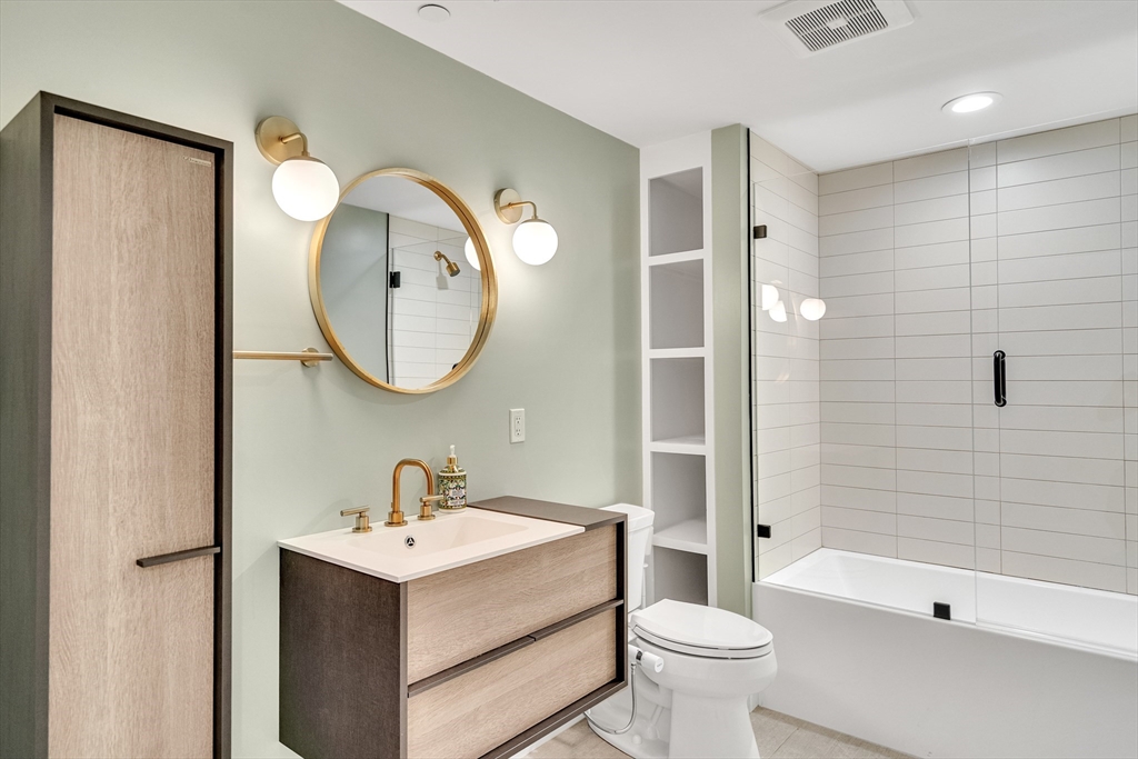 148 West 9th Street, Unit 6 Boston, MA 02127 - Photo 17 of 21 a bathroom with a toilet sink and mirror