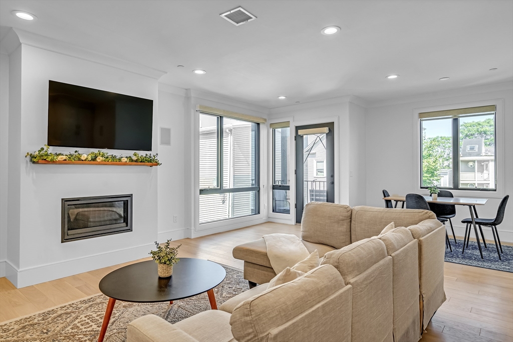 148 West 9th Street, Unit 6 Boston, MA 02127 - Photo 2 of 21 a living room with fireplace furniture and a flat screen tv