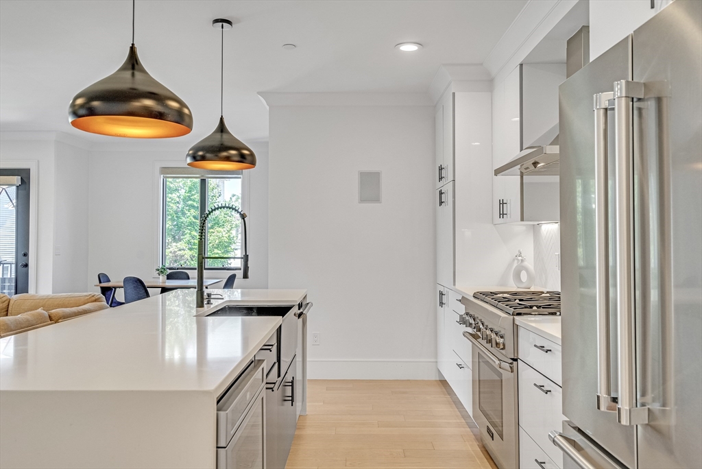 148 West 9th Street, Unit 6 Boston, MA 02127 - Photo 6 of 21 a kitchen with stainless steel appliances a stove a refrigerator and a sink