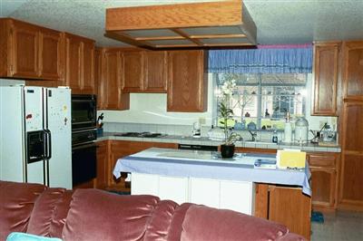 Kitchen with prep island opens to family room.