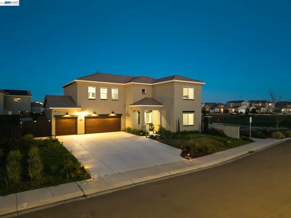 a kitchen with stainless steel appliances kitchen island granite countertop a stove a sink a refrigerator and a dining table with wooden floor