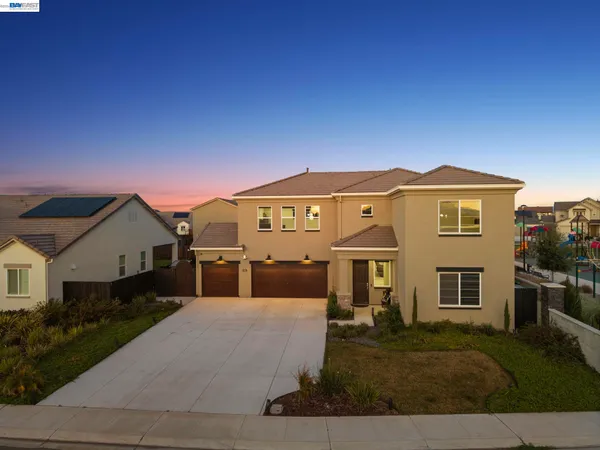 a living room with furniture and a view of kitchen
