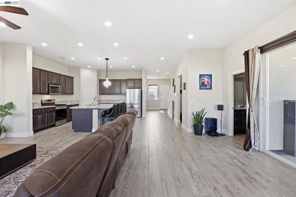 a living room with furniture ceiling fan and a window