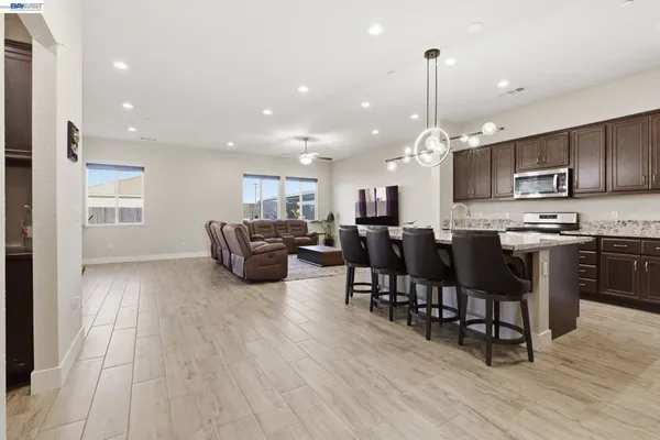 a living room with furniture a flat screen tv and a potted plant