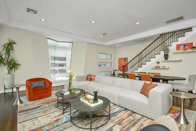 a living room with furniture a rug and a window