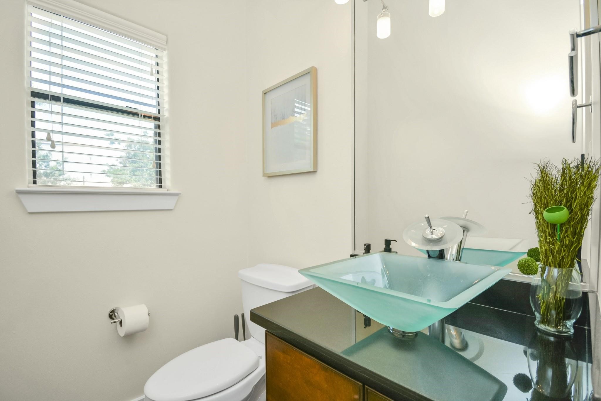 4608 Nett Street, Unit D Houston, TX 77007 - Photo 20 of 47 a bathroom with a sink a toilet and a mirror