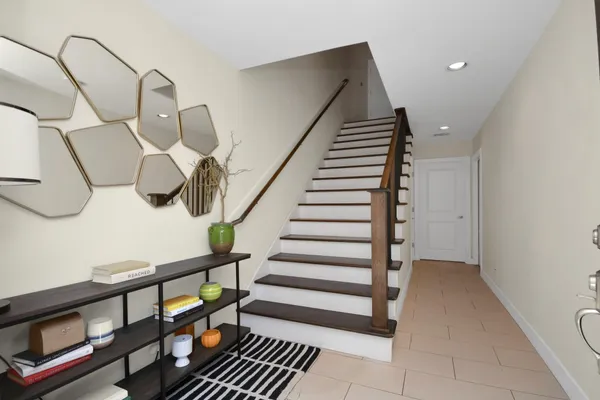 a view of entryway and hall with wooden floor