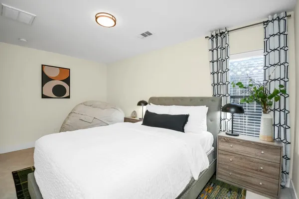 a bedroom with a bed and a window