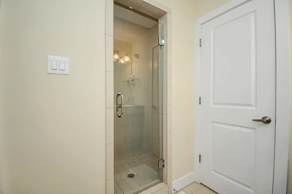 a bathroom with a glass shower door