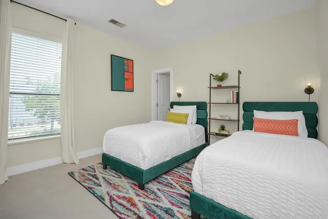 a bedroom with two beds and a window