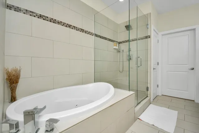 a bathroom with a bathtub and shower