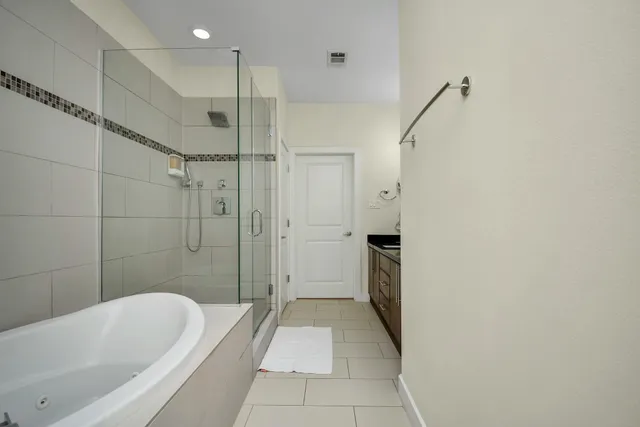 a bathroom with a bathtub and a shower