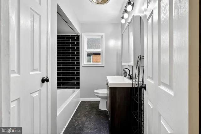 a bathroom with a sink toilet shower and a mirror