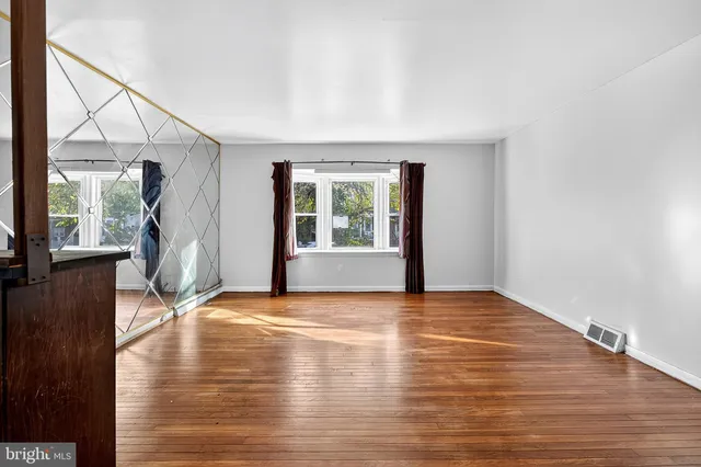 wooden floor in an empty room with a window