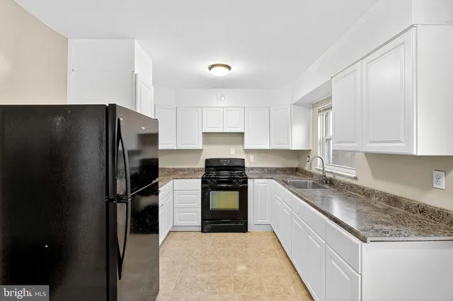 a kitchen with a refrigerator and a sink