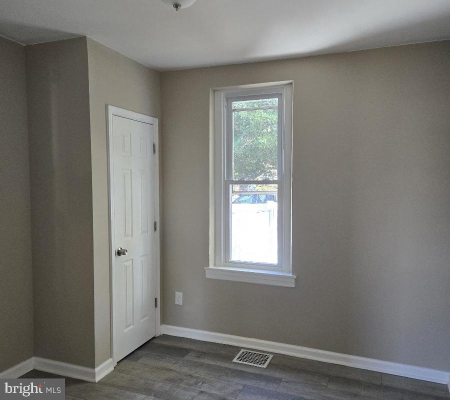524 8th Avenue Lindenwold, NJ 08021 - Photo 13 of 22 a view of an empty room with wooden floor and a window