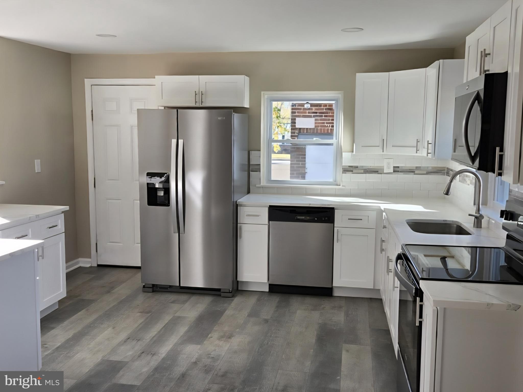 524 8th Avenue Lindenwold, NJ 08021 - Photo 8 of 22 a kitchen with a sink refrigerator and microwave