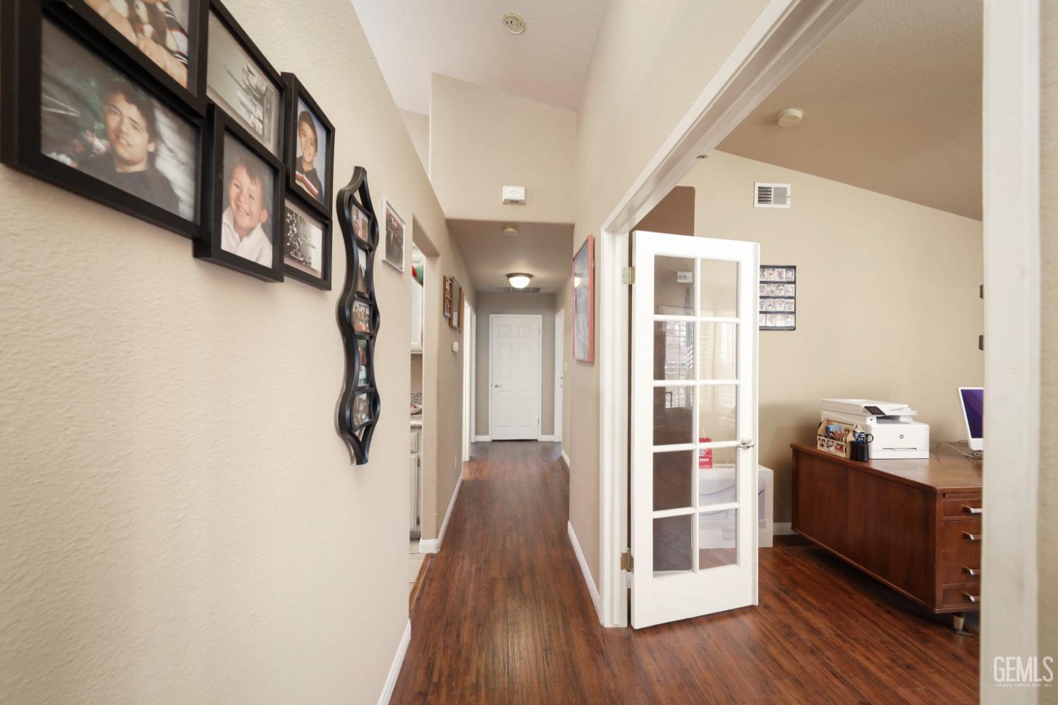 Undisclosed Address Bakersfield, CA 93312 - Photo 11 of 38 a view of a hallway with wooden floor and staircase