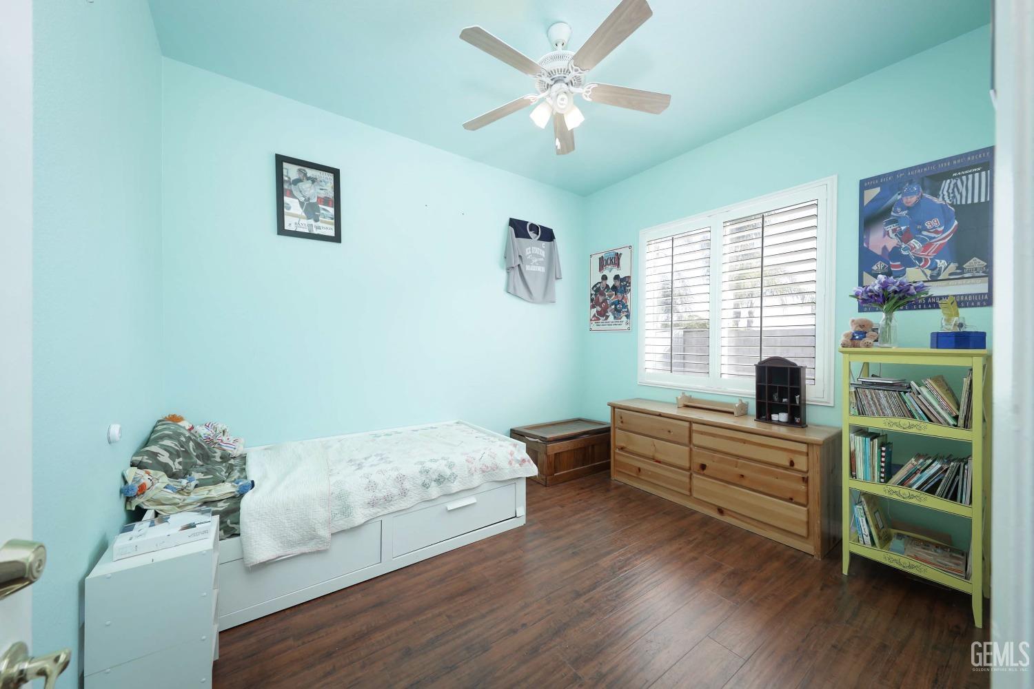 Undisclosed Address Bakersfield, CA 93312 - Photo 17 of 38 a bedroom with furniture and a wooden floor