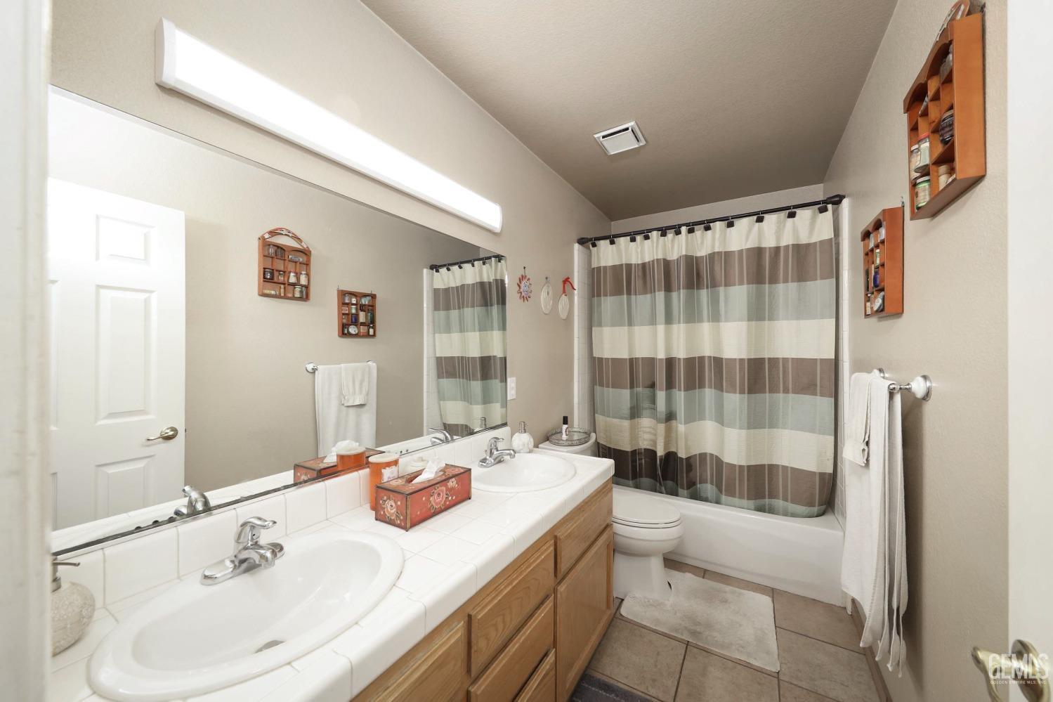 Undisclosed Address Bakersfield, CA 93312 - Photo 19 of 38 a bathroom with a sink a toilet and shower