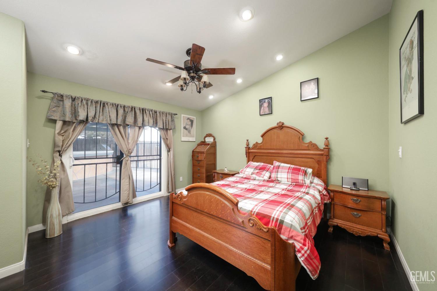 Undisclosed Address Bakersfield, CA 93312 - Photo 20 of 38 a bedroom with a bed a dresser and wooden floor