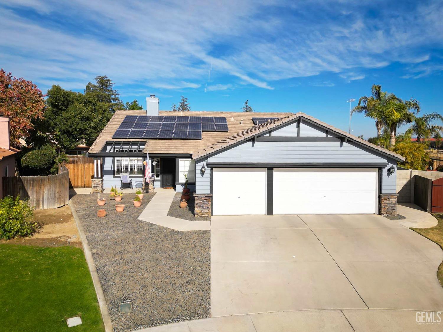 Undisclosed Address Bakersfield, CA 93312 - Photo 2 of 38 a front view of a house with a yard