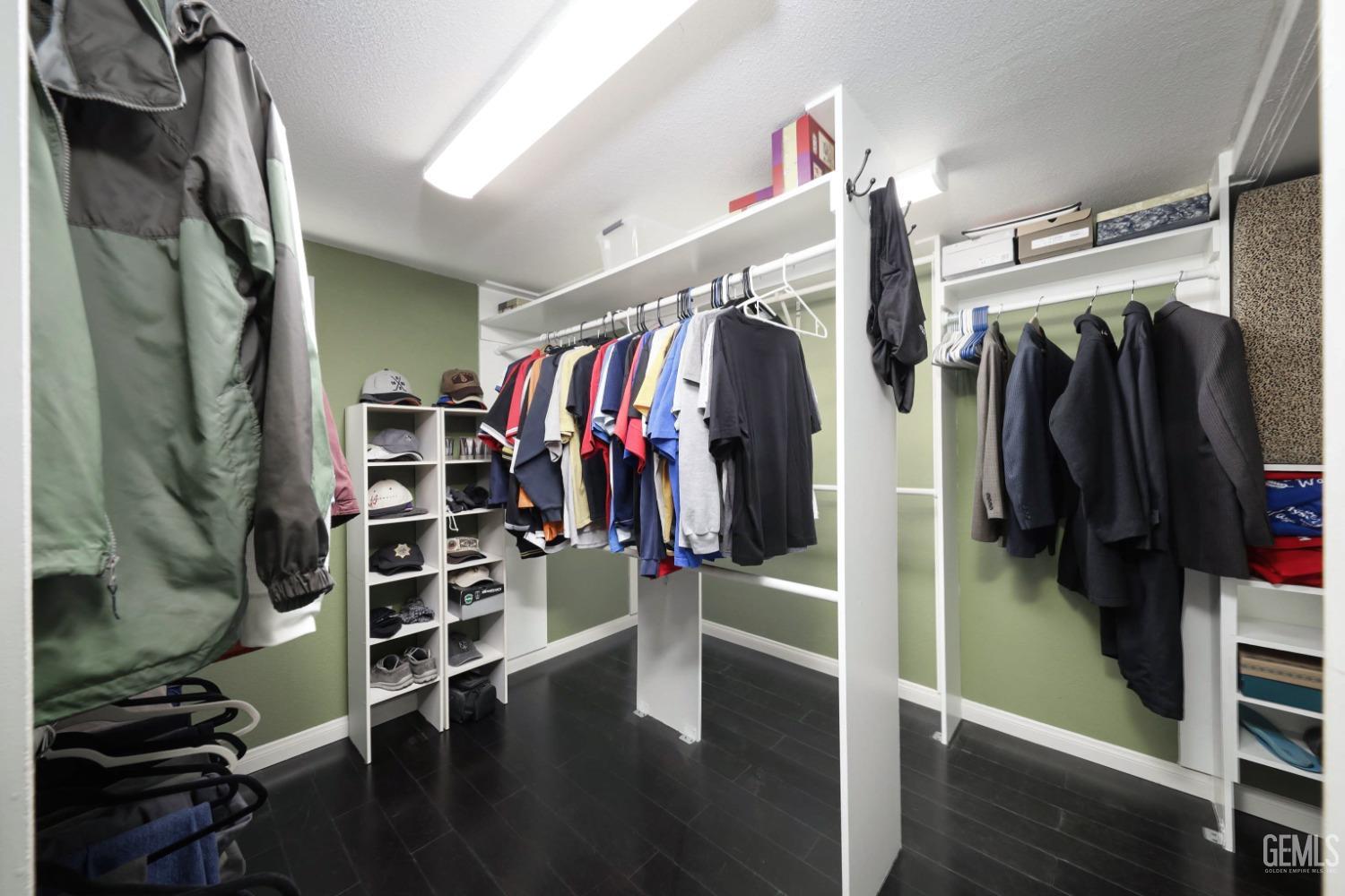 Undisclosed Address Bakersfield, CA 93312 - Photo 22 of 38 a view of walk in closet with clothes and shoes