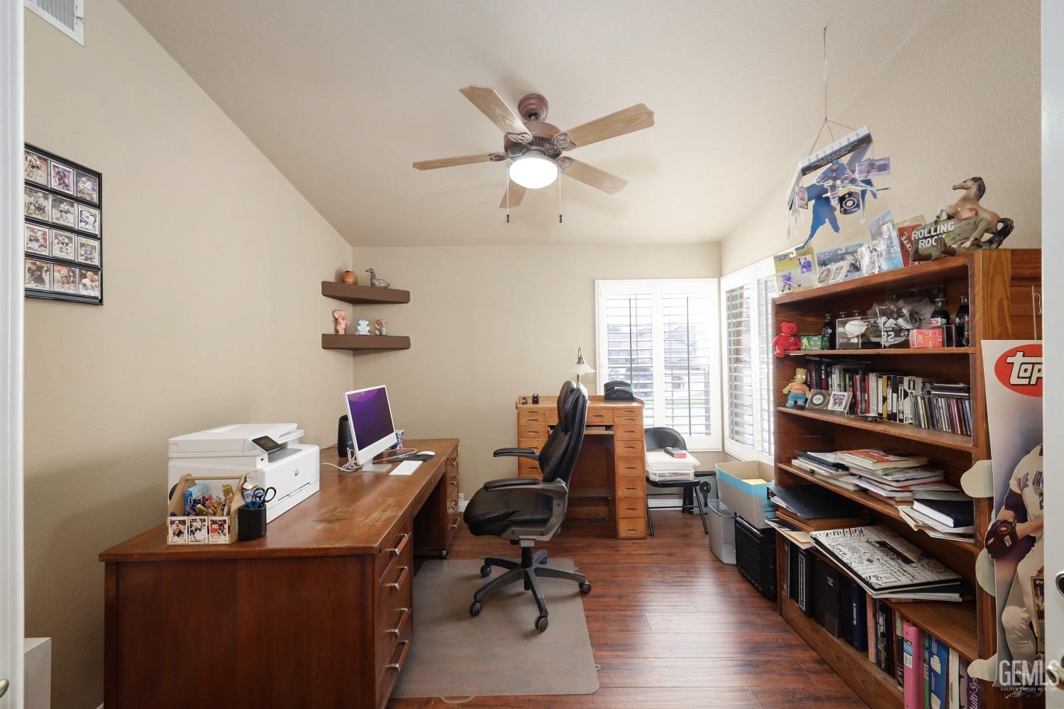 Undisclosed Address Bakersfield, CA 93312 - Photo 26 of 38 a view of a workspace with furniture and a bookshelf