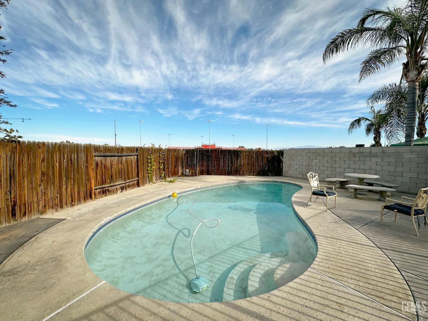 Undisclosed Address Bakersfield, CA 93312 - Photo 31 of 38 a view of a swimming pool with a lounge chairs