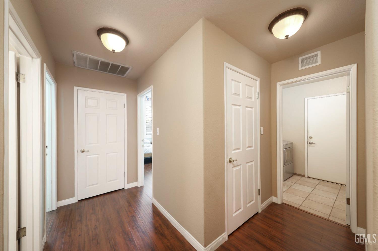 Undisclosed Address Bakersfield, CA 93312 - Photo 33 of 38 a view of a hallway with wooden floor