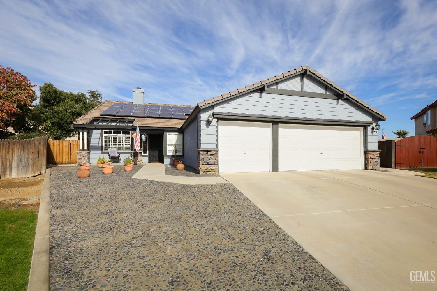Undisclosed Address Bakersfield, CA 93312 - Photo 6 of 38 a front view of a house with yard garage and chair