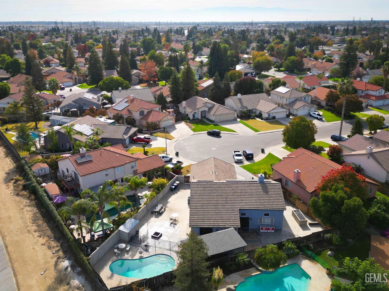 Undisclosed Address Bakersfield, CA 93312 - Photo 8 of 38 an aerial view of multiple houses with yard