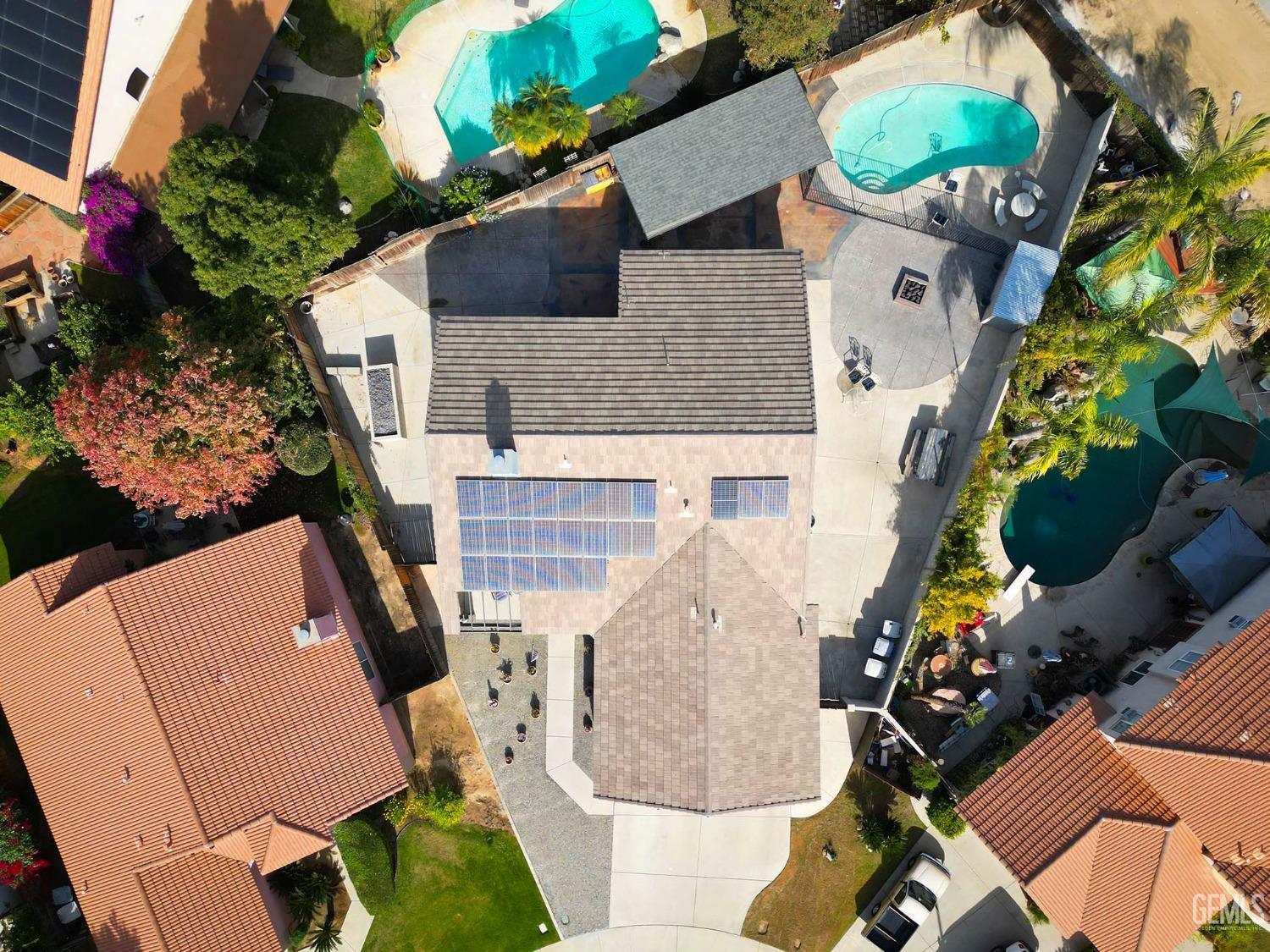 Undisclosed Address Bakersfield, CA 93312 - Photo 9 of 38 an aerial view of a house with a swimming pool and a yard