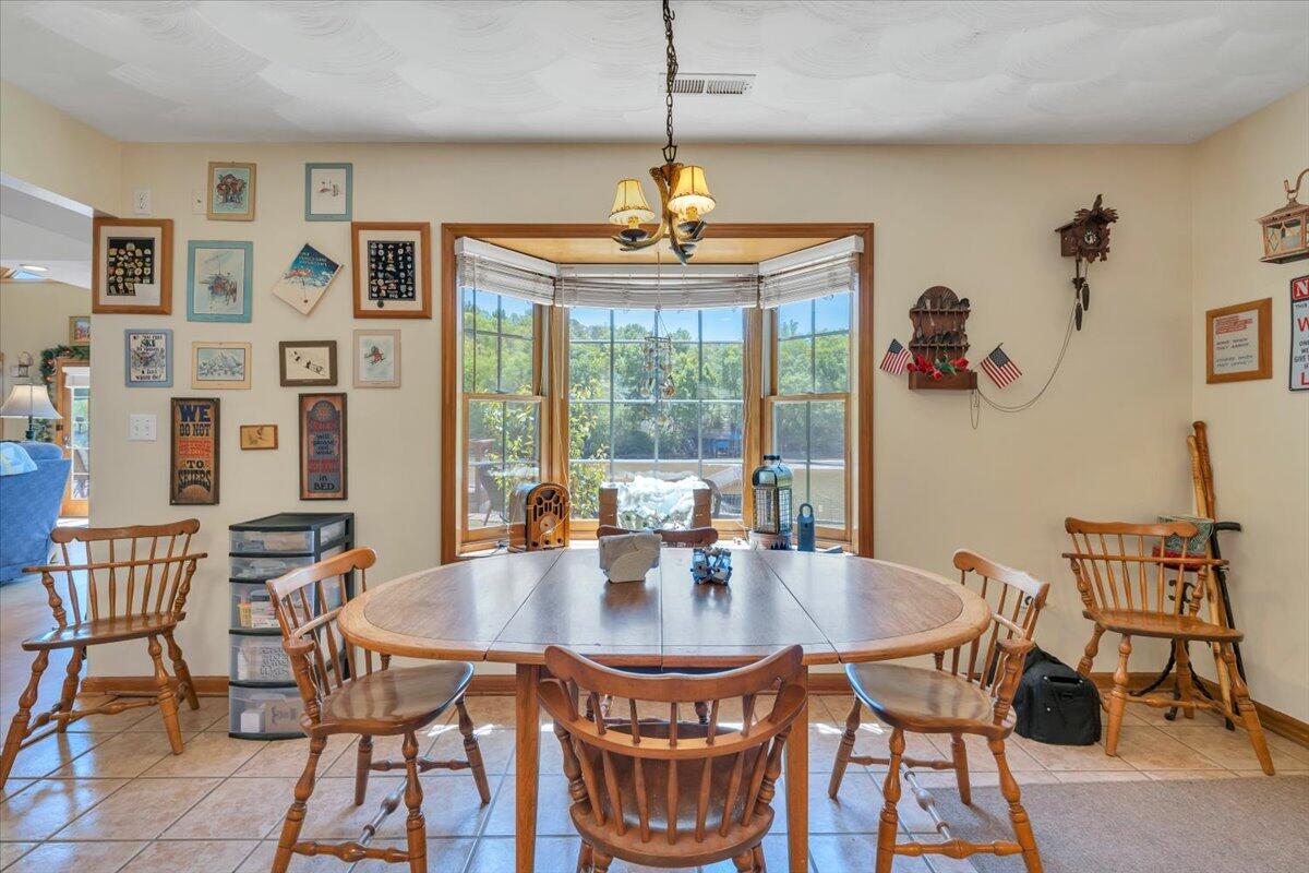 531 Brookwood Road Wirtz, VA 24184 - Photo 21 of 57 a dining room with furniture a chandelier and window