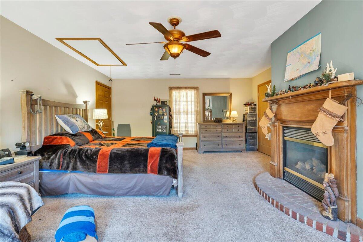 531 Brookwood Road Wirtz, VA 24184 - Photo 25 of 57 a living room with furniture a ceiling fan and a fireplace