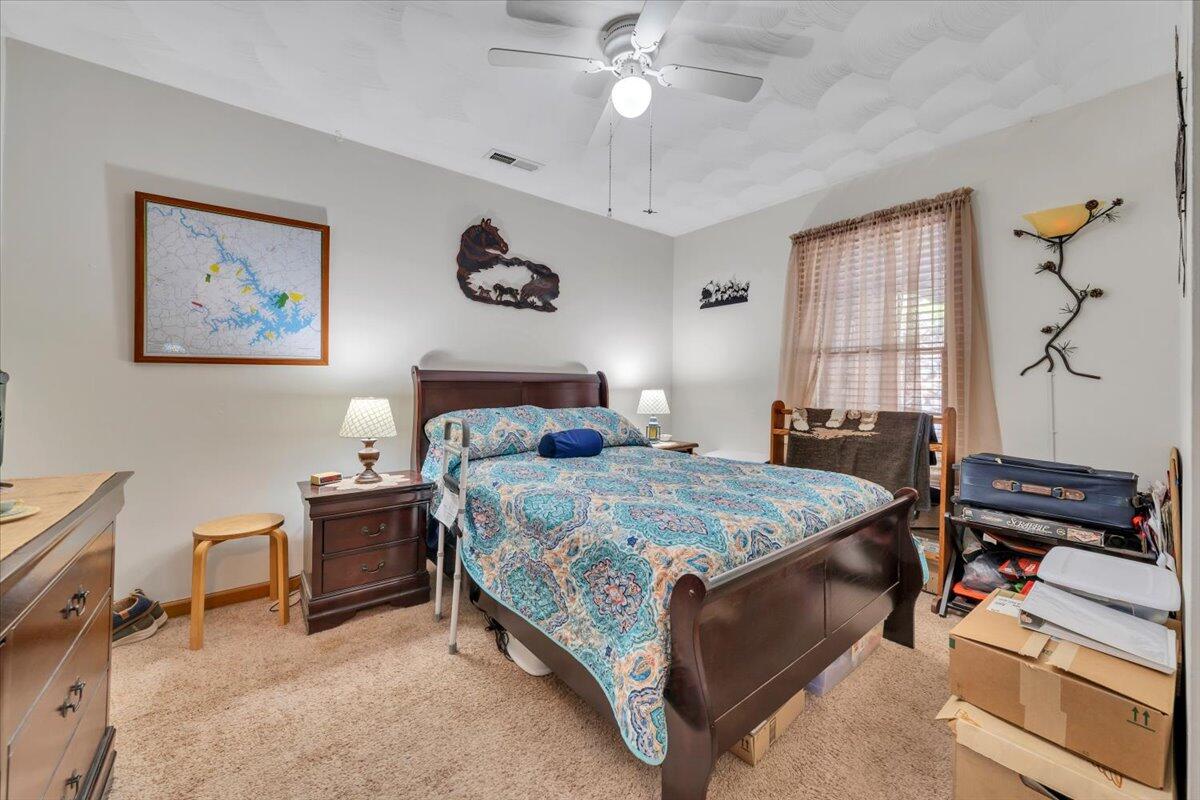 531 Brookwood Road Wirtz, VA 24184 - Photo 32 of 57 a bedroom with a bed and a chandelier