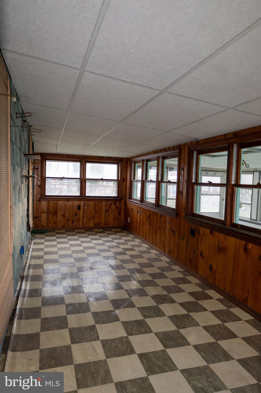 4398 South Bowers Road Milford, DE 19963 - Photo 31 of 54 a big room with wooden floor and windows