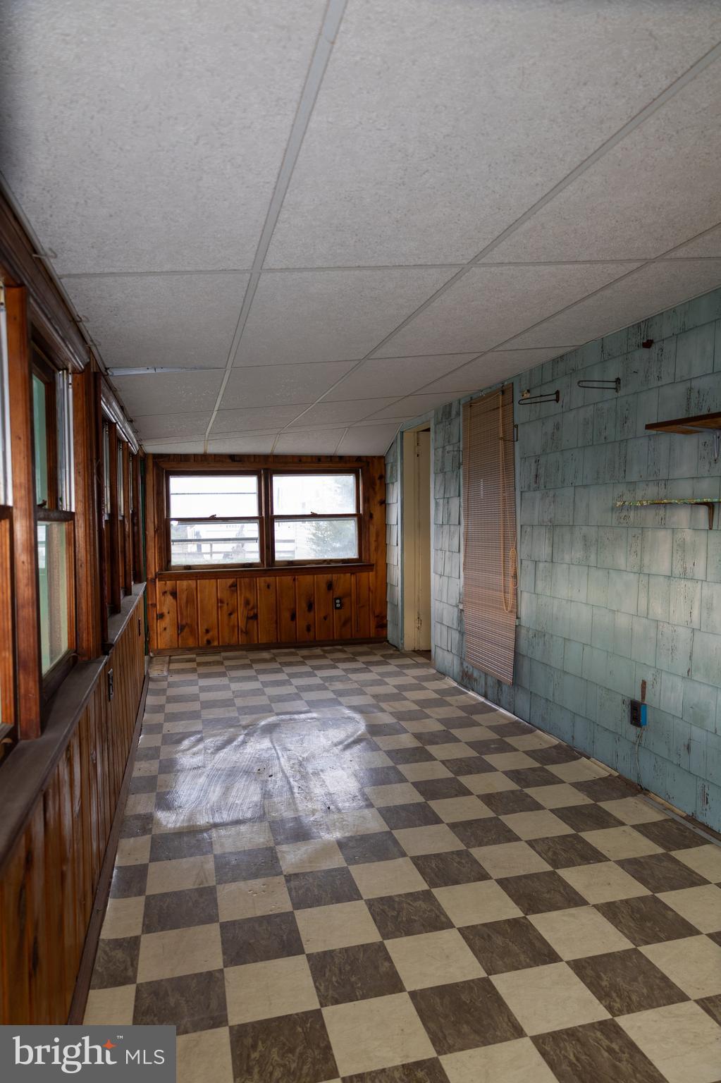 4398 South Bowers Road Milford, DE 19963 - Photo 32 of 54 a view of a hallway with a black white checkered floor