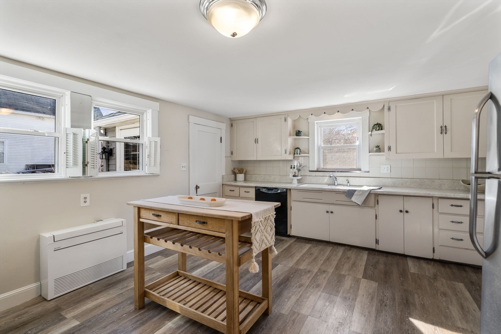 166 Hopedale Street Hopedale, MA 01747 - Photo 7 of 27 a kitchen with a stove a sink and dishwasher with wooden floor