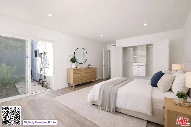 a bedroom with a bed and a night stand