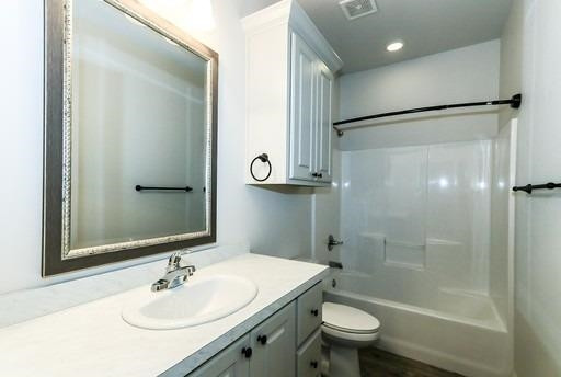 2518 111th Street, Unit A Lubbock, TX 79423 - Photo 11 of 14 a bathroom with a sink toilet and shower