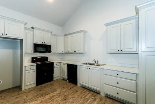an empty room with ceiling fan and window