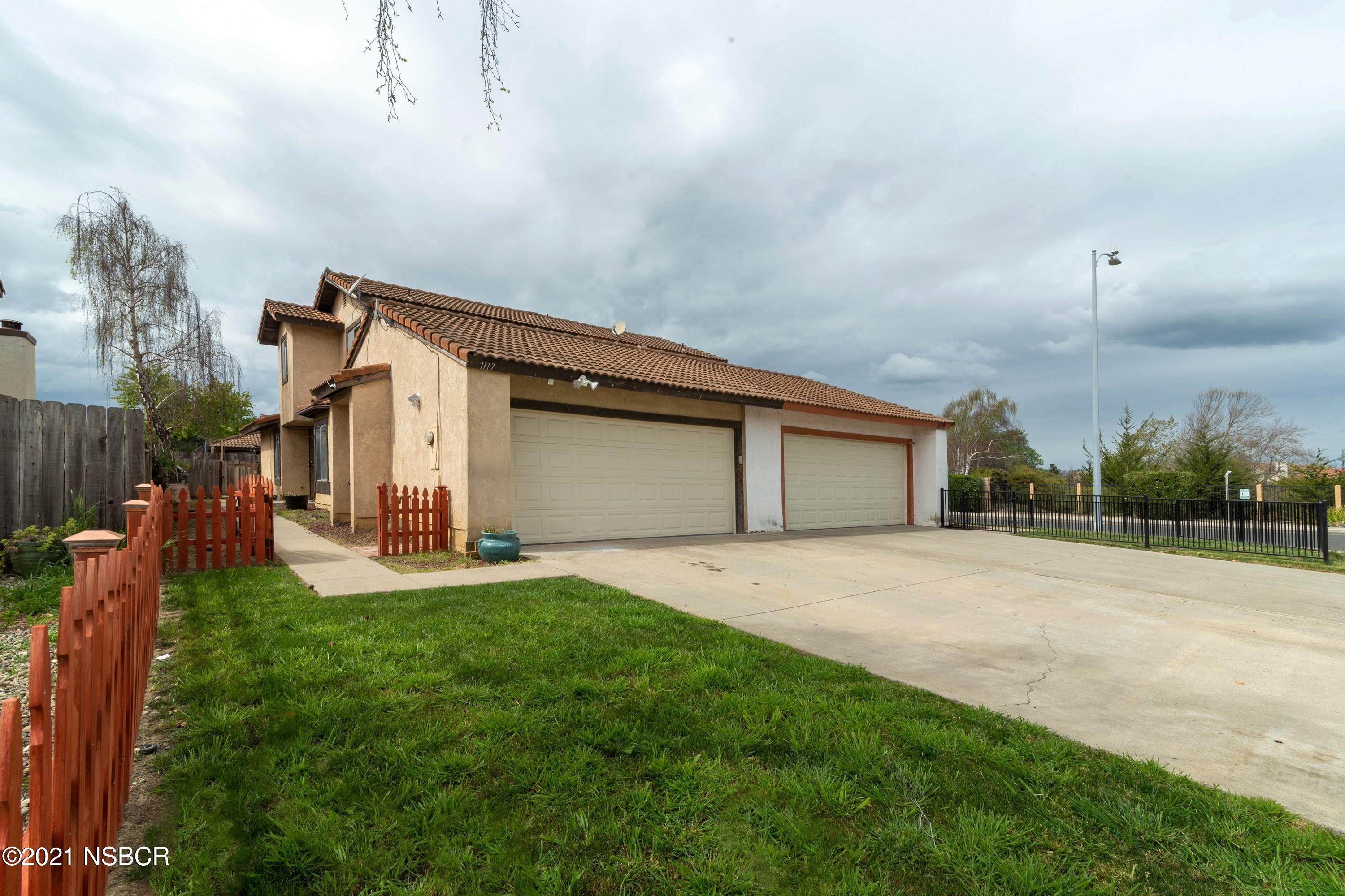 a big house with a big yard and more large trees