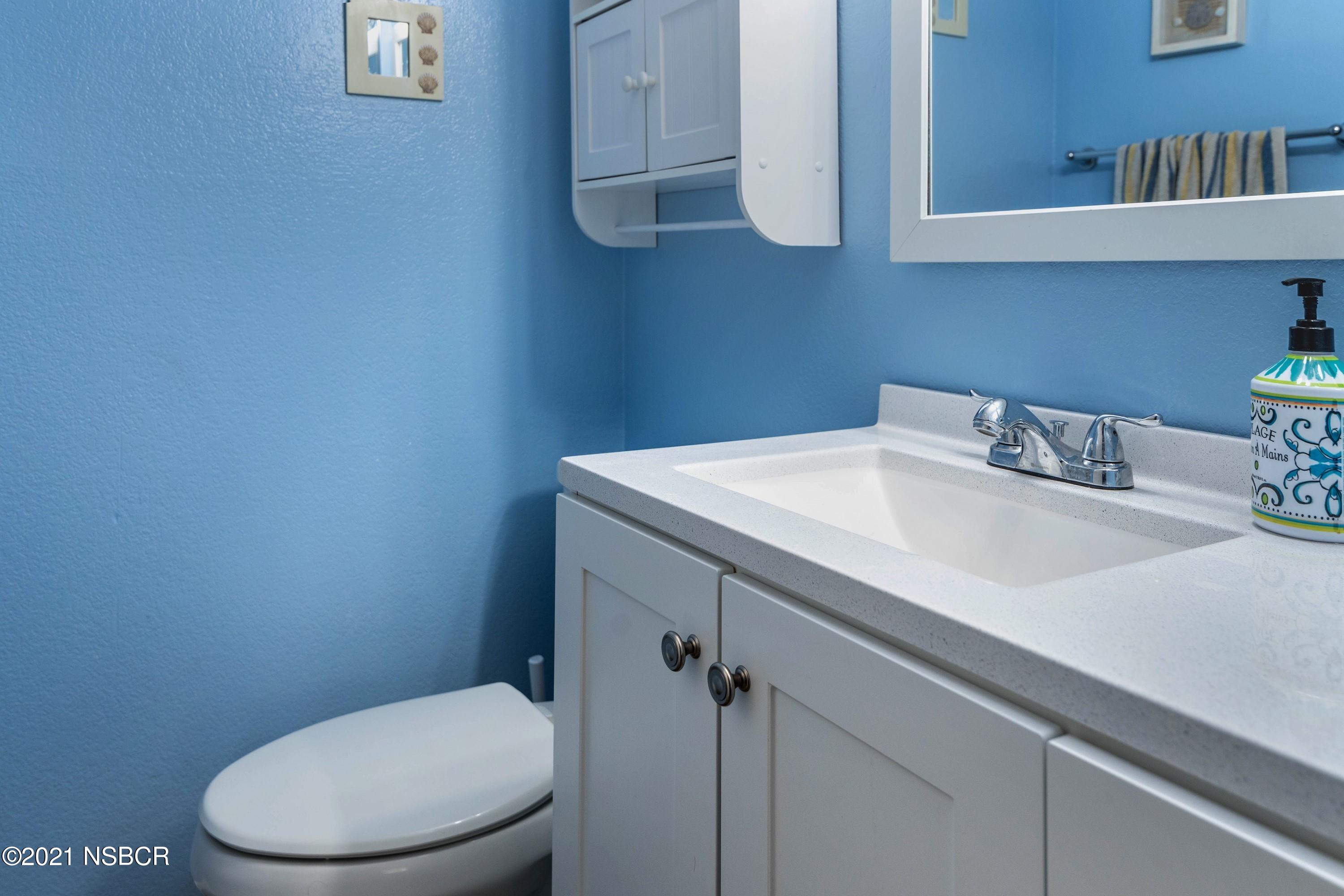 1117 Parkside Way Lompoc, CA 93436 - Photo 12 of 15 a bathroom with a sink a toilet and vanity