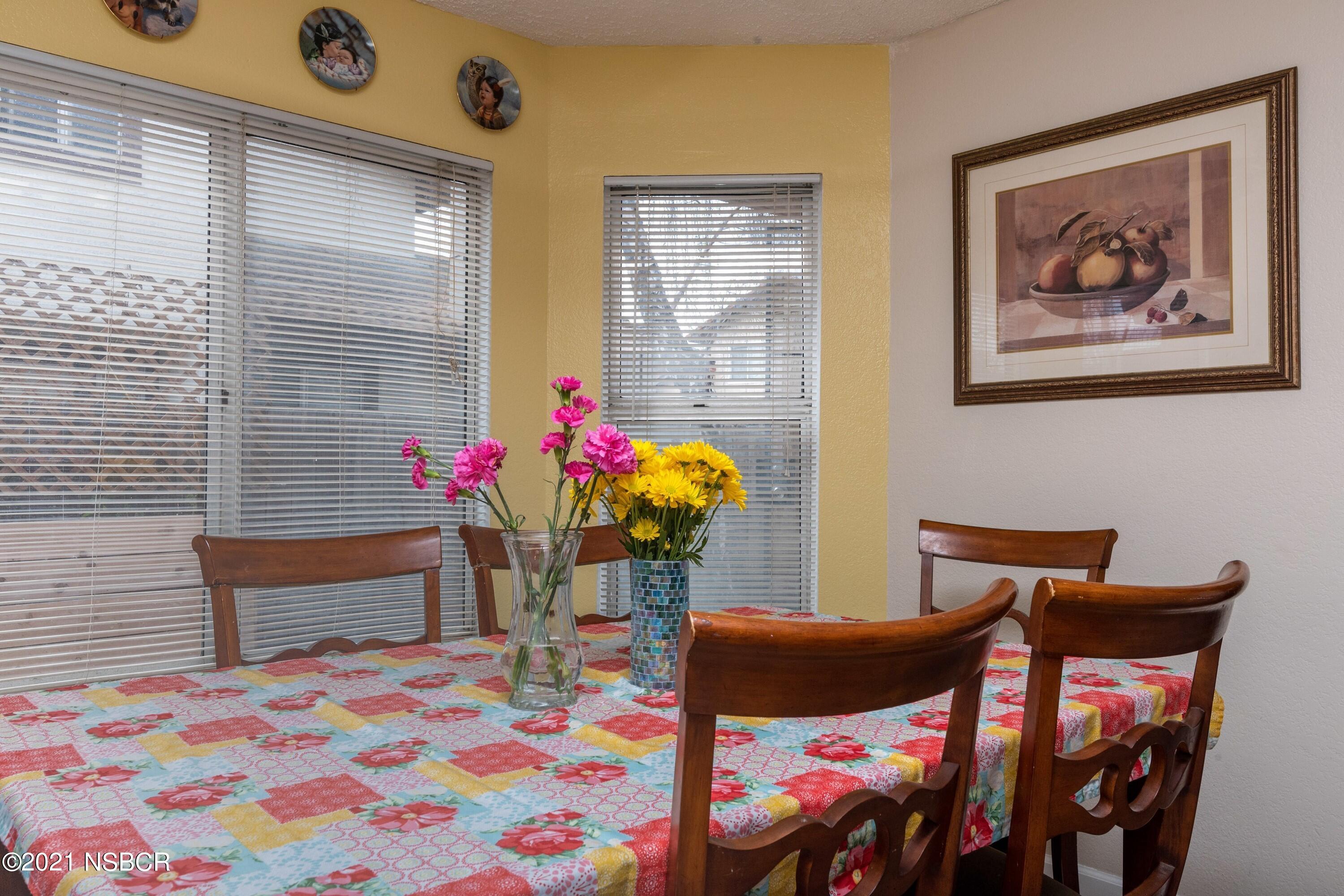 1117 Parkside Way Lompoc, CA 93436 - Photo 6 of 15 a bedroom with a bed and a chandelier