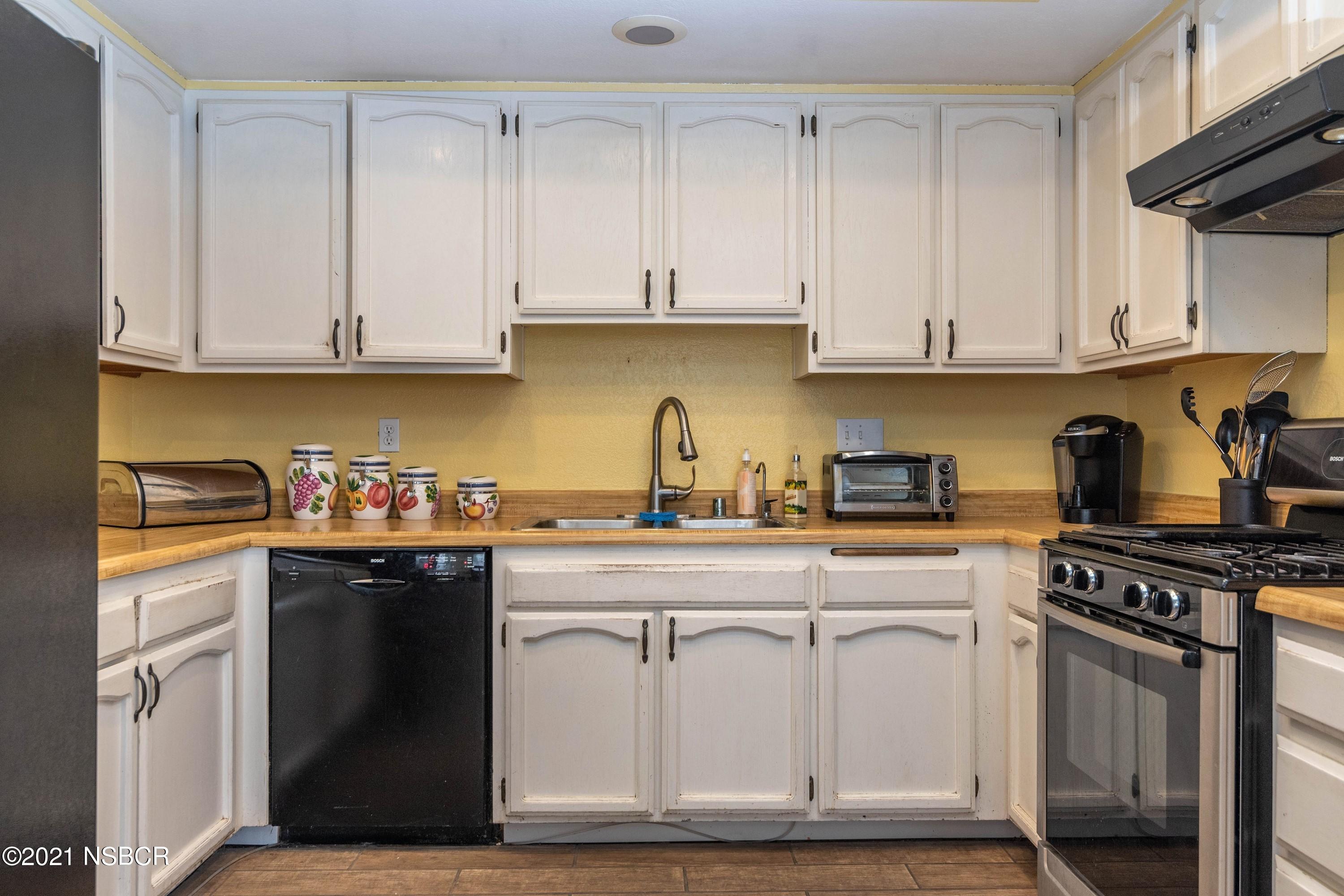 1117 Parkside Way Lompoc, CA 93436 - Photo 7 of 15 a kitchen with cabinets appliances and a sink