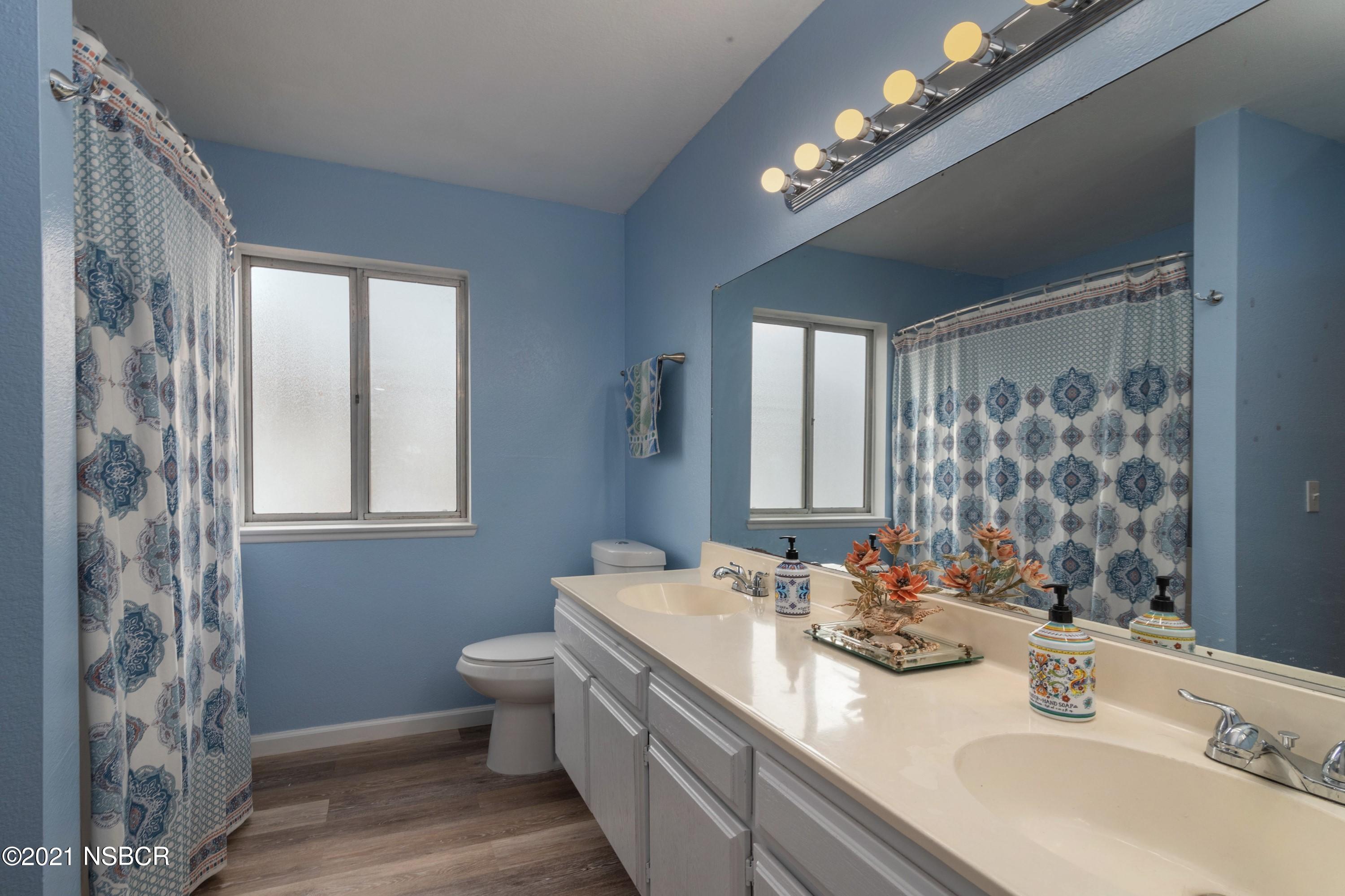 1117 Parkside Way Lompoc, CA 93436 - Photo 10 of 15 a bathroom with a double vanity sink toilet and a mirror