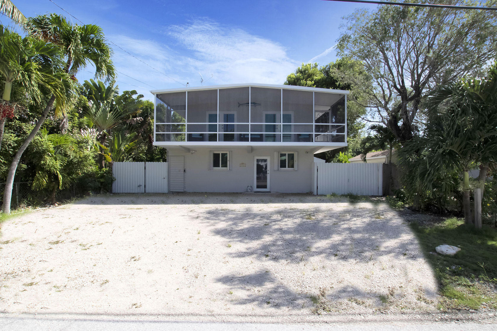 a view of a house with a wooden fence